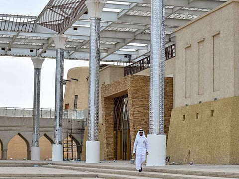 A Saudi man walks past a mall in the newly reconstructed historical quarter of Awamiya, a Shiite-majority town on Saudi Arabia's oil-rich eastern coast on April 28, 2019. 