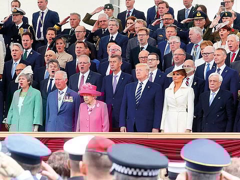 Front row from left: French President Emmanuel Macron, Britain’s Prime Minister Theresa May, Britain’s Prince Charles, Britain’s Queen Elizabeth II, United States President Donald Trump, US First Lady Melania Trump, Greek President Prokopis Pavlopoulosm and German Chancellor Angela Merkel at the commemoration of the 75th anniversary of the D-Day landings, in Portsmouth, southern England, yesterday.