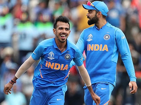 India's Yuzvendra Chahal, left, celebrates the dismissal of South Africa's Rassie van der Dussen during the Cricket World Cup match at the Hampshire Bowl in Southampton. 