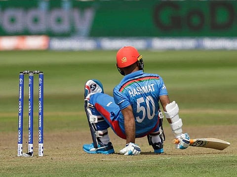 Afghanistan's Hashmatullah Shahidi loses his balance after ducking a bouncer during the Cricket World Cup match between Afghanistan and Australia at Bristol County Ground in Bristol, England, Saturday, June 1, 2019.