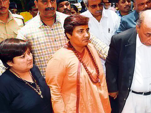 Indian MP for Prime Minister Narendra Modi's Bharatiya Janata Party (BJP) Sadhvi Pragya Thakur (C) arrives to appear in the special court in Mumbai.