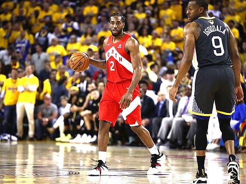 Kawhi Leonard #2 of the Toronto Raptors handles the ball on offense against the Golden State Warriors in the second half during Game Four of the 2019 NBA Finals at ORACLE Arena