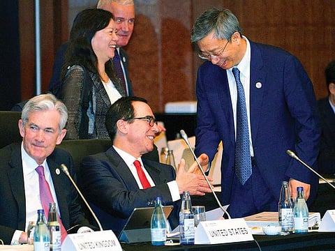 Steven Mnuchin, US Treasury Secretary and China’s Central Bank Governor Yi Gang shake hands at the G20 Finance Ministers’ and Central Bank Governors’ Meeting.