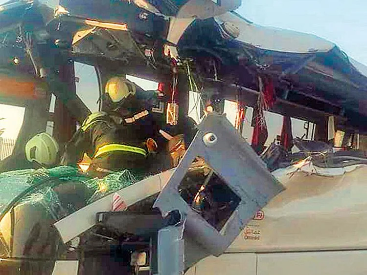 Rescue workers extricate passengers from the bus.