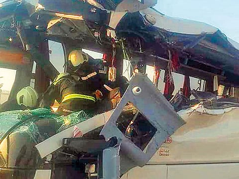 Rescue workers extricate passengers from the bus.