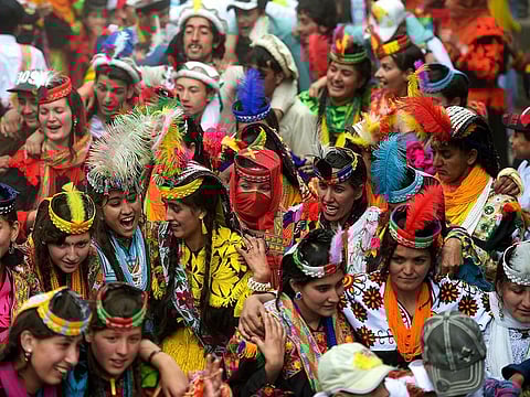 Kalash women wearing traditional dresses dance as they celebrate 'Joshi', a festival to welcome the arrival of spring, at Bumburate village in the mountainous valleys in northern Pakistan.
