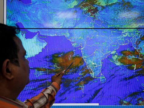An India Meteorological Department scientist monitors Cyclone Vayu inside his office in Ahmedabad, India, June 11, 2019.  