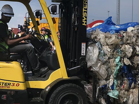 A Westport Holdings Bhd employee uses a forklift to move trash during a presentation to the media of containers filled with plastic waste at Port Klang, Selangor, Malaysia. 
