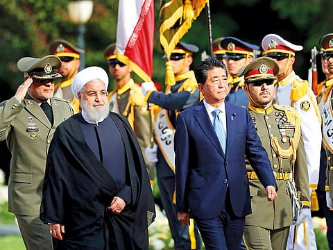 Japanese Prime Minister Shinzo Abe reviews a guard of honour as he is welcomed by  Iranian President Hassan Rouhani at the Saadabad Palace in Tehran.