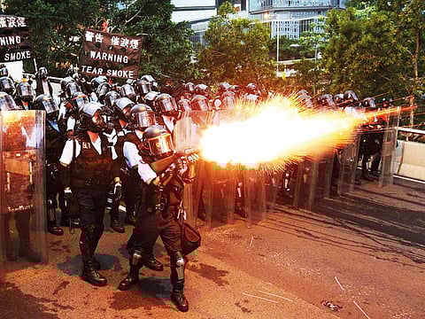 Police officers fire a tear gas during a demonstration against a proposed extradition bill in Hong Kong, China. 
