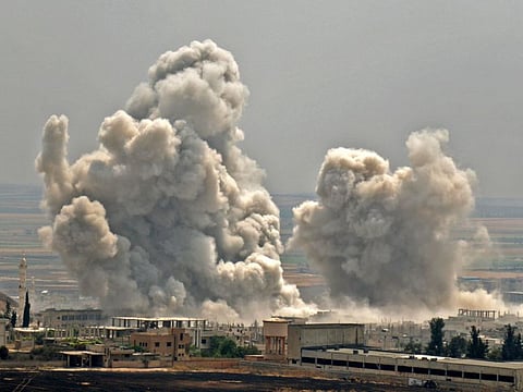 Plumes of smoke rise following reported Syrian government forces' bombardment on the town of Khan Sheikhun in the southern countryside of the jihadist-held Idlib province, on June 7, 2019.
