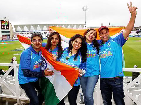 India fans pose in the rain at the match between India and New Zealand at Trent Bridge, Nottingham. 