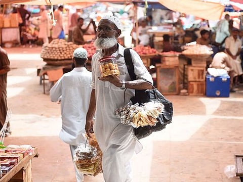 A vendor sells dry fruits at a market in Karachi. 