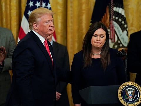 U.S. President Donald Trump stands with White House Press Secretary Sarah Sanders after it was announced she will leave her job at the end of the month.