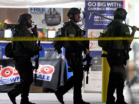 Heavily armed police officers exit the Costco following a shooting inside the wholesale warehouse in Corona, Calif.,  Friday, June 14, 2019. 