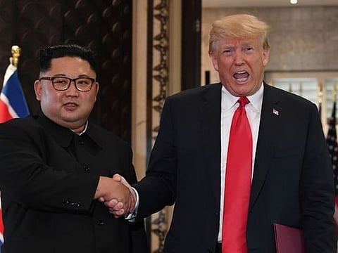 US President Donald Trump and North Korea's leader Kim Jong-un shake hands following a signing ceremony during their historic US-North Korea summit, at the Capella Hotel on Sentosa island in Singapore on June 12, 2018 . They had pledged change and progress. But now they are gripped by diplomatic recriminations after a failed second meeting in Hanoi.