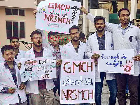Medical student hold placards showing solidarity with the intern doctor who was assaulted in West Bengal, at Gauhati Medical College in Guwahati.