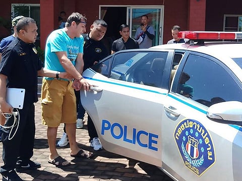 Italian national Francesco Galdelli (C) after he was arrested on the outskirts of Pattaya.