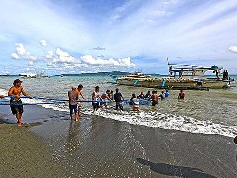 Local fishermen pull 'F/B GemVer 1' to the shores of San Jose, Occidental Mindoro after it was reportedly rammed by a Chinese vessel near Reed Bank (known in Manila as Recto Bank) in the South China Sea, also known in Manila as the West Philippine Sea. 