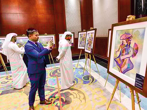 Visitors admire works by artist Manuel D. Baldmor at the Philippine 121st Independence Day reception in Dubai.