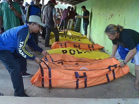Men arrange body bags containing victims from the boat that sank in the sea between Sapudi and Gili islands, at Dungkek district in Sumenep, East Java province, Indonesia, June 18, 2019 in this photo taken by Antara Foto.