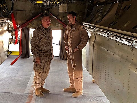Marine Gen. Frank McKenzie, head of U.S. Central Command, confers with an Air Force officer below the bomb bay of a B-52 bomber on Friday, June 7, 2019 at al-Udeid air base in Qatar.