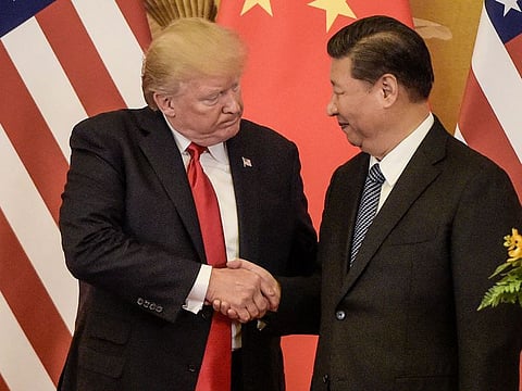In this file photo taken on November 9, 2017, US President Donald Trump (L) shakes hand with China's President Xi Jinping at the end of a press conference at the Great Hall of the People in Beijing.