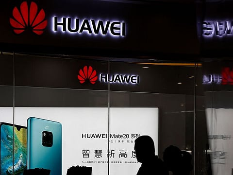 In this May 29, 2019 file photo, a man walks past a Huawei retail store in Beijing. 