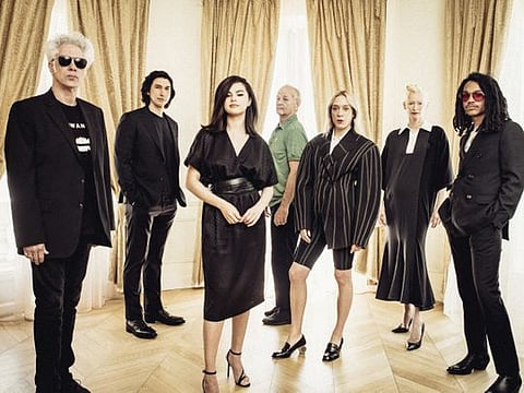 From left: The writer-director Jim Jarmusch with his “The Dead Don’t Die” cast, including Adam Driver, Selena Gomez, Bill Murray, Chloë Sevigny, Tilda Swinton and Luka Sabbat, in Cannes, France, May 14, 2019. To make the dark, zombie comedy, Jarmusch wrote letters to actors he had grown to trust.