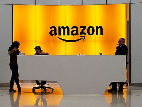 File photo: People stand in the lobby for Amazon offices in New York. 