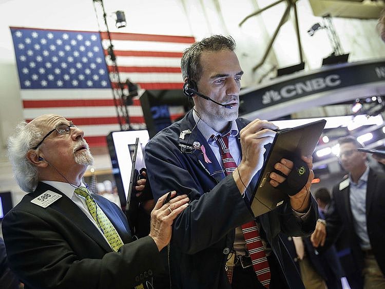 Traders work on the floor of the New York Stock Exchange