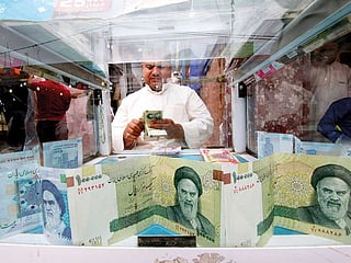 FILE: A man counts Iranian rials at a currency exchange shop, before the start of the U.S. sanctions on Tehran, in Basra, Iraq November 3, 2018. Picture taken November 3, 2018. 
