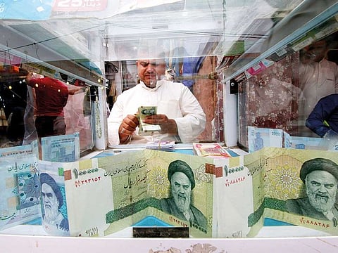 FILE: A man counts Iranian rials at a currency exchange shop, before the start of the U.S. sanctions on Tehran, in Basra, Iraq November 3, 2018. Picture taken November 3, 2018. 