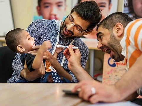Dr Mahdi Shkoukani, a staff physician at Cleveland Clinic Abu Dhabi, screening one of the young patients.
