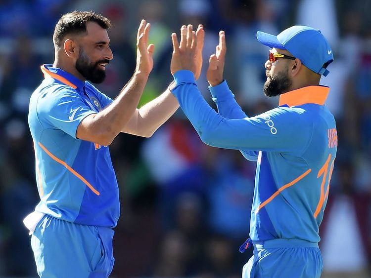 India's Mohammad Shami (left) celebrates with Virat Kohli