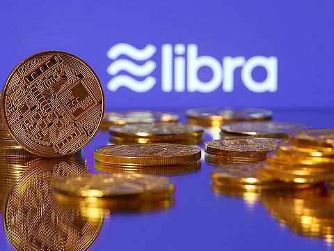 Representations of virtual currency are displayed in front of the Libra logo in this illustration picture. 