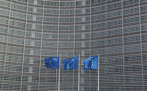 European Union flags fly outside the European Commission headquarters in Brussels, Belgium.