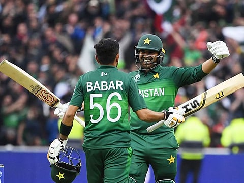Pakistan's Babar Azam (L) celebrates with teammate Haris Sohail after scoring a century (100 runs) during the match against New Zealand at Edgbaston in Birmingham. 