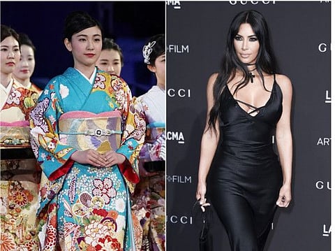 This combination photo shows a woman wearing a kimono during an award ceremony of the ISU World Team Trophy Figure Skating competition in Fukuoka, Japan on April 13, 2019, left, and reality star Kim Kardashian West at the 2018 LACMA Art+Film Gala in Los Angeles on Nov. 3, 2018. West has earned some backlash from Japanese people and others on social media who object to her appropriation of the traditional Japanese kimono as part of the name of her upcoming shapewear line. West announced her Kimono Solutionwear on Instagram, Tuesday, June 25, 2019. Some people on social media said the name, which West trademarked, is an inappropriate take centuries-old kimono clothing.  (AP Photo/Toru Hanai, left, and Richard Shotwell/Invision/AP)