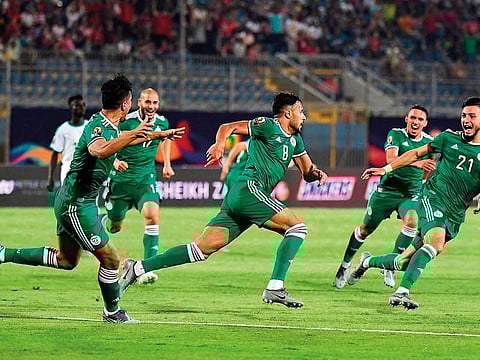 Algeria’s Youcef Belaili (centre) celebrates after scoring against Senegal