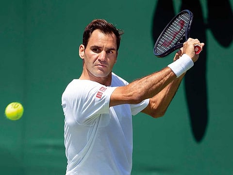 Roger Federer hits a ball during a training session at Wimbledon.