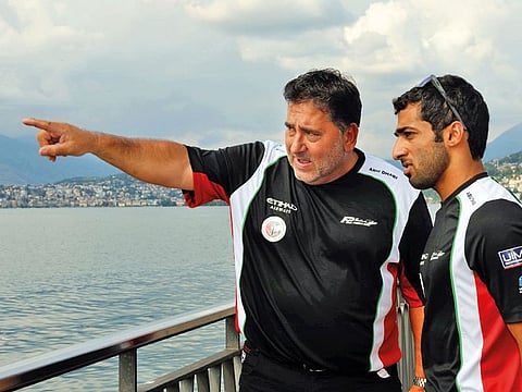 Rashid Al Qamzi (right) gets some last-minute instructions from Abu Team Dhabi manager Guido Cappellini in Kaunas, Lithuania.