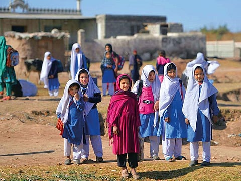 Afghan refugee girls leave school at a refugee camp on the outskirts of Islamabad in 2019.