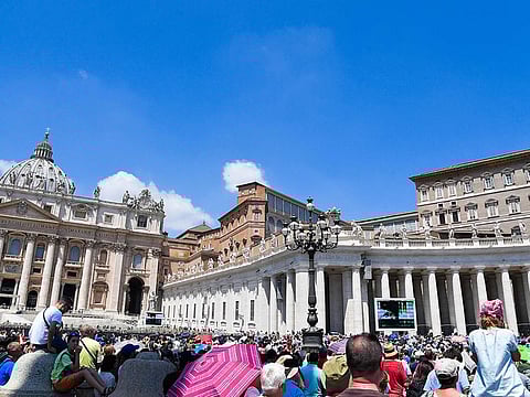 Pope Francis (Top R) addresses worshipers from the window of the Apostolic palace overlooking St. Peter's square during the weekly Angelus prayer on June 23, 2019 at the Vatican. 