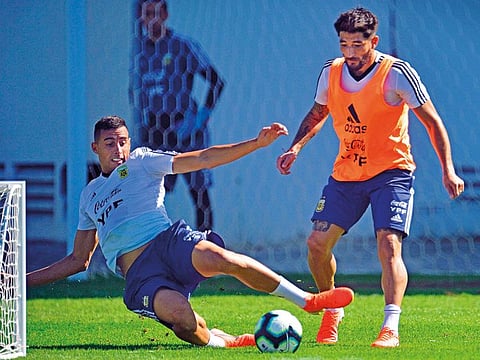 Argentina’s Milton Casco (right) and Ramiro Funes Mori vie for the ball during training in Rio de Janeiro, ahead of their Copa America semi-final against Brazil today.