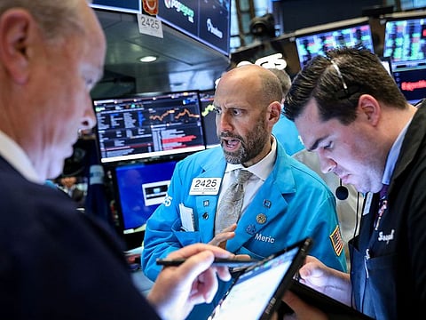 Traders work on the floor at the New York Stock Exchange. As global markets anticipate a highly contested US election little over a week away, investors will meanwhile await any new hints this week on who will likely win the presidency.