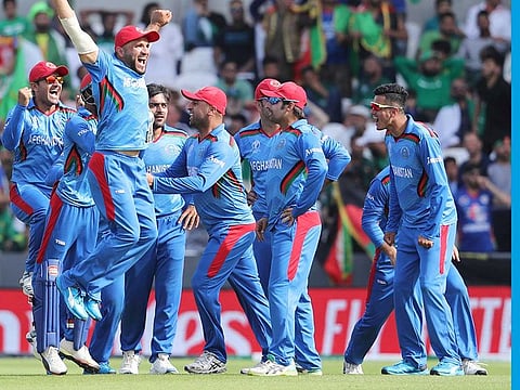 Afghanistan cricketers celebrate the dismissal of Pakistan's captain Sarfaraz Ahmad during their World Cup match at Headingley in Leeds on June 29, 2019. 