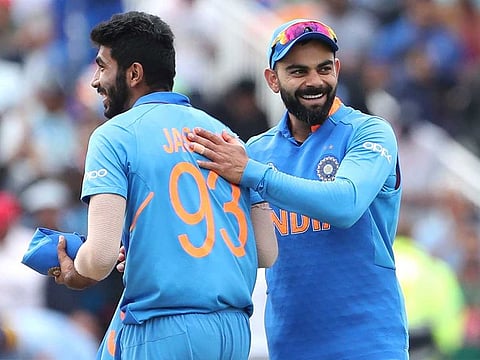 India's captain Virat Kohli, right, celebrates with teammate Jasprit Bumrah after their win over Bangladesh in the World Cup match at Edgbaston in Birmingham. 