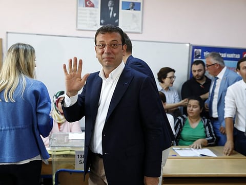 Ekrem Imamoglu, candidate of the secular opposition Republican People's Party, or CHP, waves to the media at a polling station in Istanbul, on June 23, 2019. 