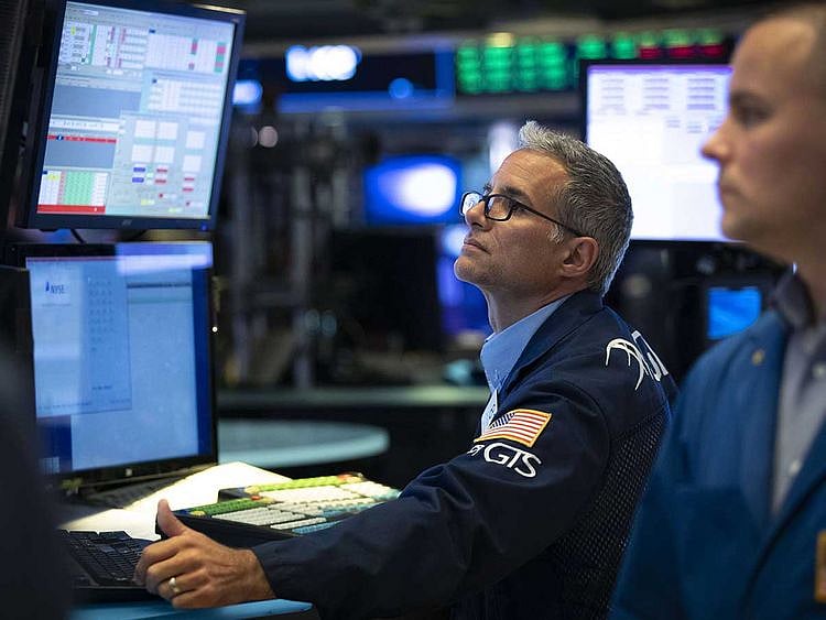 Traders work on the floor of the New York Stock Exchange (NYSE)